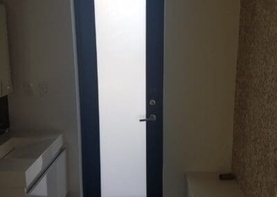 A narrow door with a full window film