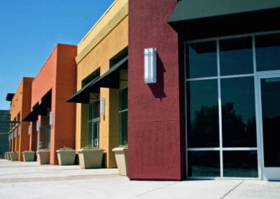 A row of stores on the side of a street.